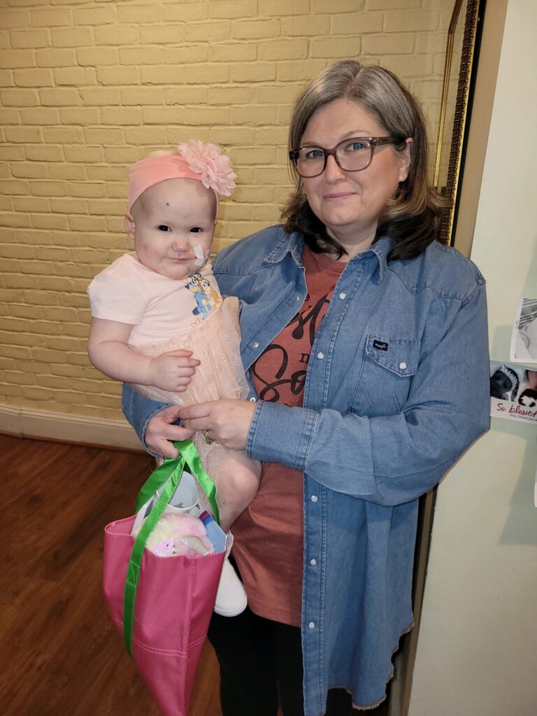 Bristol being held by her grandmother Deborah.