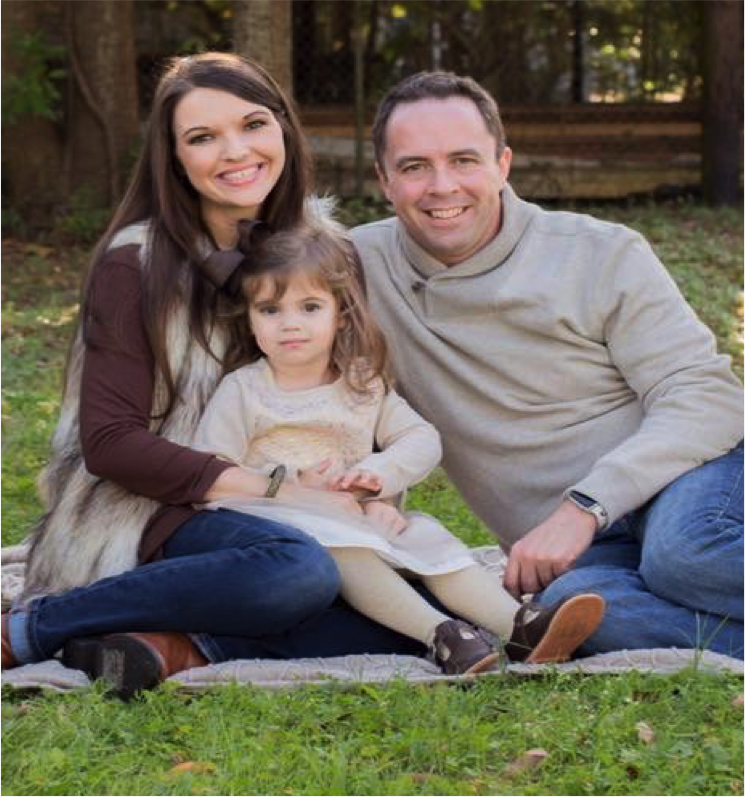 The Smith family smiling at the camera with little Ella Grace front and center.