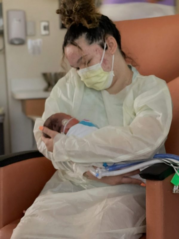 Courtney holding Isaiah in the hospital.