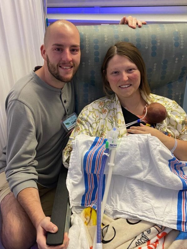 The Simmons sitting with baby Leo at the hospital.