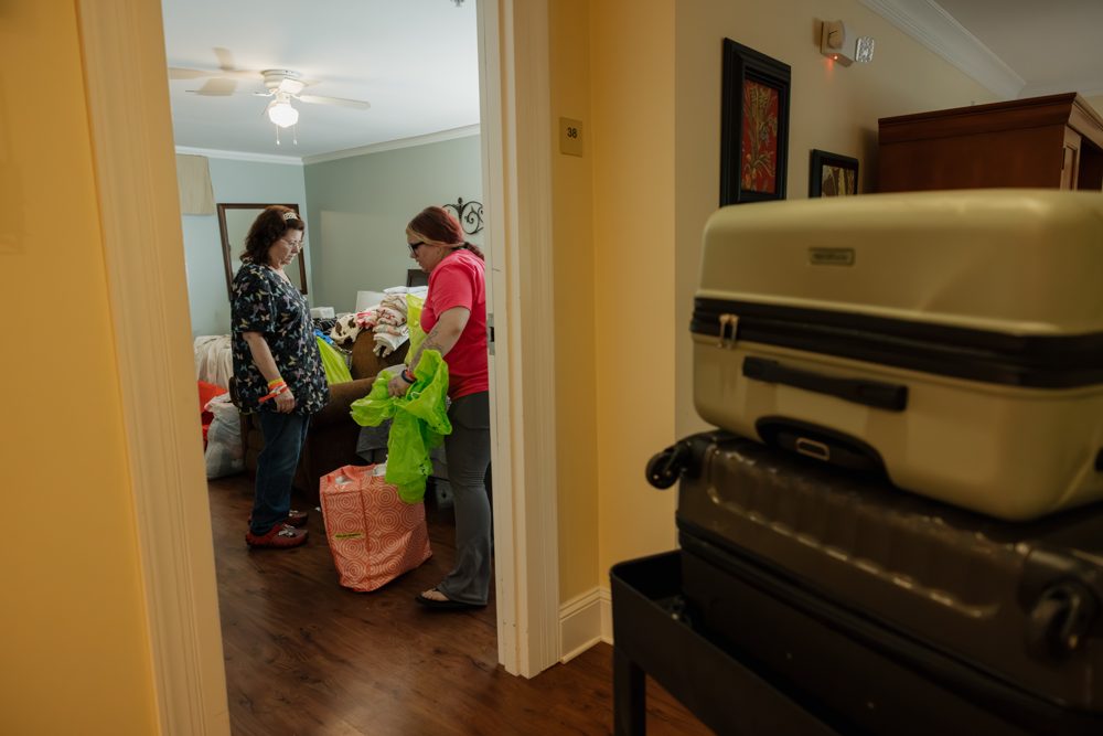 Families settling into a guest room with their luggage