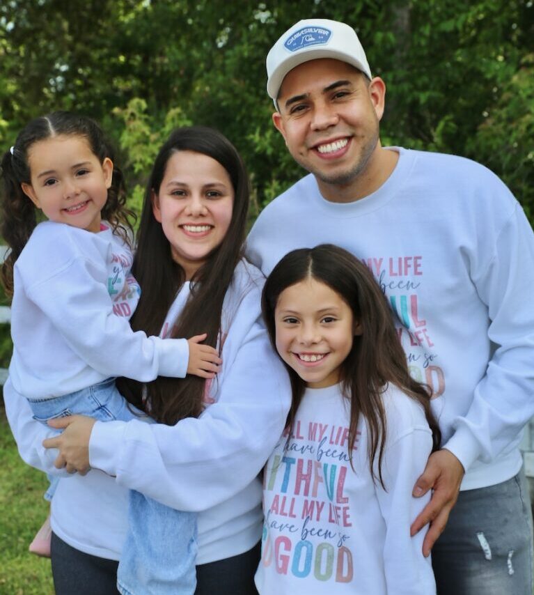 The Blanco-Valera family smiling at the camera.