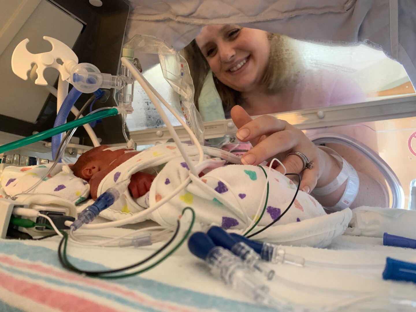 Savannah looking in on one of her twins in the NICU.